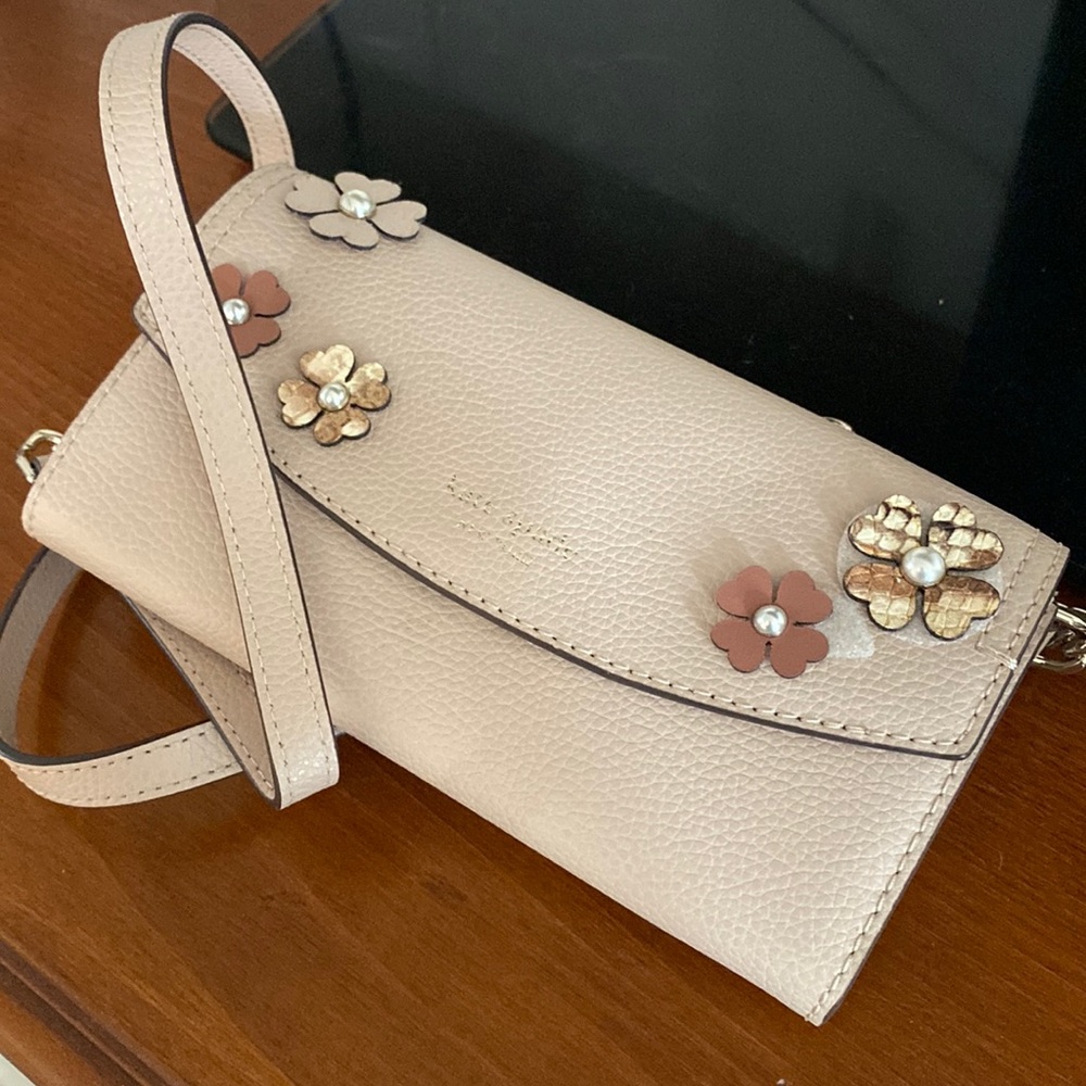 New. Kate spade purse.  Flowers on side.  Very pretty.  Strap.